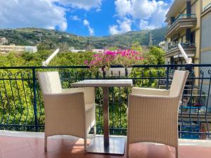 a table and chairs on a balcony with a view at Bougainvillea Relais in Sorrento