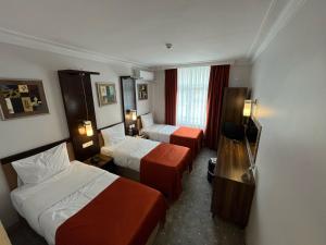 Postel nebo postele na pokoji v ubytování Hotel Topkapı
