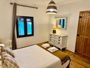 a bedroom with a bed and a dresser and a window at Montado Village in Portel +31 photos