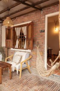 a patio with a hammock and a brick wall at Canaan Beach Home in Phú Quốc +141 photos