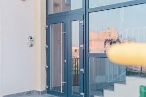 a glass door of a building with a window at Penthouse Râșnov 80mp, balcon 30mp in Râşnov