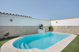 a large swimming pool in the middle of a yard at La Brujita in Chiclana de la Frontera