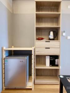 a kitchen with a refrigerator in a book shelf at The Reef 綠芙 in Green Island