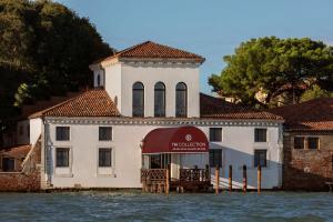 a building on the water next to a body of water at NH Collection Grand Hotel Palazzo Dei Dogi in Venice