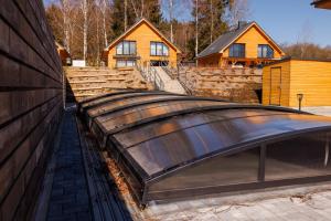 a house with a metal roof on the side of a building at Apartmán Hůrka in Horní Planá