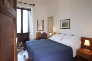 a hotel room with a bed and a window at Villa Astoria in Taormina