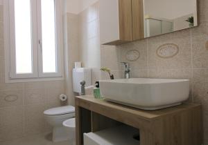a bathroom with a white sink and a toilet at Forli con Park view style e comfort in Forlì +18 photos