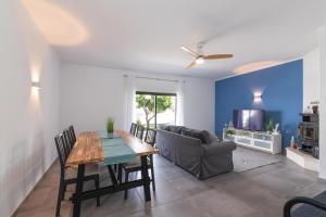 a living room with a table and a couch at Brisa do Rio - Portimao in Portimão
