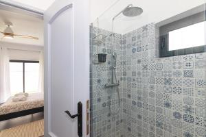 a bathroom with a shower with blue tiles at Brisa do Rio - Portimao in Portimão +29 photos
