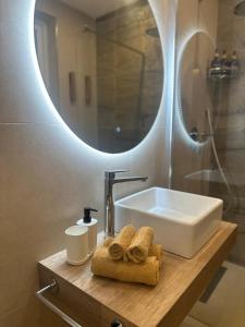 a bathroom with a sink and a mirror at Desibu Collection - The Pearl St Julian's in St Julian's +39 photos