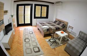 a living room with a bed and a table at Villa Dudanov in Ohrid