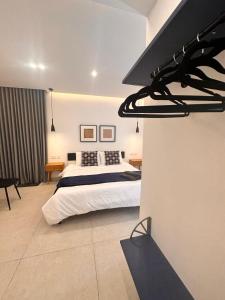a bedroom with a bed and a black hood at Desibu Collection - The Pearl St Julian's in St Julian's