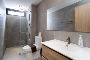a bathroom with a toilet and a sink and a shower at Townhouse in Khet Phayathai - Ari in Bangkok +47 photos