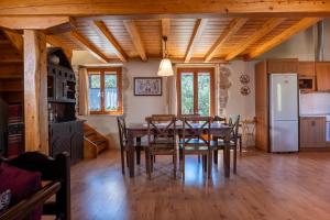 a kitchen and dining room with a table and chairs at Katouna Stone House in Katouna