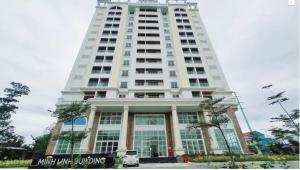 a tall white building with a sign in front of it at Gạo 88 House in Thôn Dương Phẩm