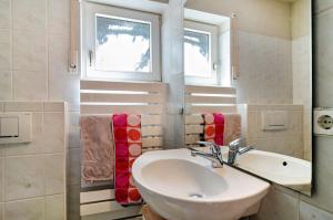 a bathroom with a sink and a window at Bodenseenahe ruhige Ferienoase in Uhldingen-Mühlhofen +20 photos