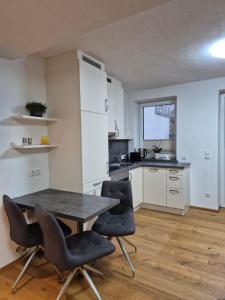 a kitchen with a table and chairs in a room at Appartements Haus Olympia in Innsbruck