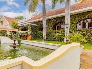 a house with a fountain in front of it at Casta Diva Boutique Hotel in Pretoria