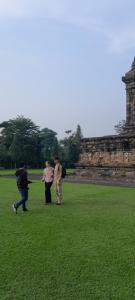 a group of people standing in a field with a kite at Driver tour Borobudur, Rice Terace & hiden scared waterfall in Blaburan