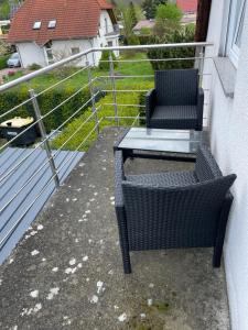 a patio with two chairs and a table on a balcony at Eastside-Apartment WHG 01 in Senftenberg