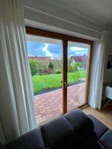 a living room with a large sliding glass door at Gemütliche Ferienwohnung im Herzen des Schwarzwaldes in Niedereschach