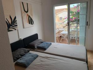 a bedroom with a bed with two pillows on it at Charming duplex with pool in Torrevieja
