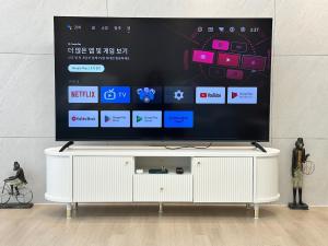 a flat screen tv sitting on top of a white entertainment center at 킨텍스 홍대 서울역 김포공항 고양종합운동장- Foreigner Only in Goyang