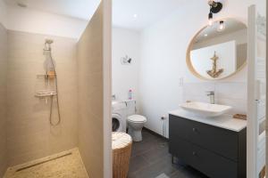 a bathroom with a sink and a toilet and a mirror at Le refuge Champenois in Verneuil +16 photos