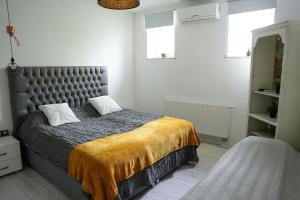 um quarto com uma cama com um cobertor amarelo em Apartment Marijin Dvor Deluxe em Saraievo