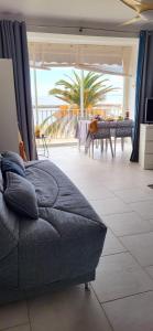 Una sala de estar con un sofá y vista al mar. en Le Royal 180-degree view of the sea !, en Le Grau-du-Roi 30 fotos más