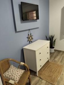 a room with a white dresser and a chair at La casa di mamma in Monopoli