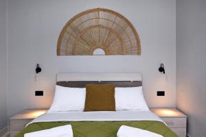 a bedroom with a bed with a rattan headboard at El Dorado Corner with Hot Tub in Chania +22 photos