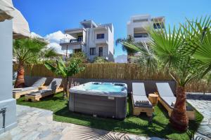 a backyard with a hot tub and palm trees at El Dorado Corner with Hot Tub in Chania