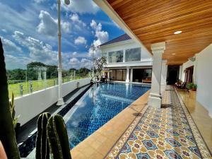 a swimming pool in the backyard of a house at Rumah Malika in Munggu