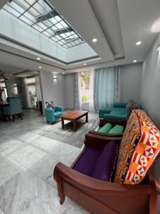 a living room with a couch and a table at La villa des anges in Kribi +33 photos