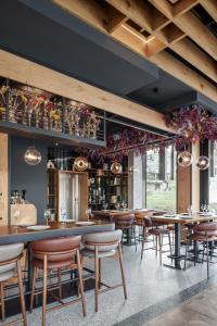 a restaurant with tables and chairs and a bar at Galeria Jahorina Luxury Ski Apartments and Restaurant in Jahorina
