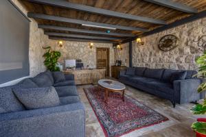 a living room with two blue couches and a table at Latona Stone Palace in Nevsehir