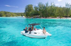 a group of people on a boat in the water at Fare Aito in Moorea