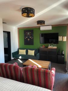 a living room with a couch and a tv at Galleria Betliar in Betliar