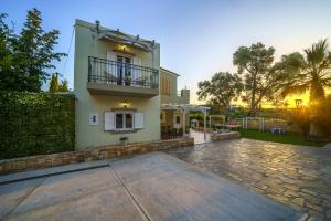 a large house with a balcony and a courtyard at Elia Villa in Angeliana