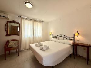 a bedroom with a large white bed and a chair at AT060 Villa Ortenbach in Ifach +38 photos