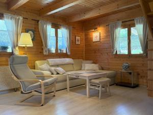 a living room with a couch and a table at Počitniška hiša z dvema spalnicama Sauna & Jacuzzi in Gorica pri Slivnici