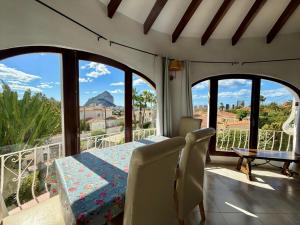 a room with a table and chairs on a balcony at AT060 Villa Ortenbach in Ifach