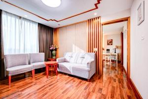 a living room with two chairs and a table at Dancenter Bangkok Travellers Hotel in Bangkok +38 photos