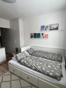 a white bed in a room with a bed frame at Apartmán v centre in Nové Mesto nad Váhom