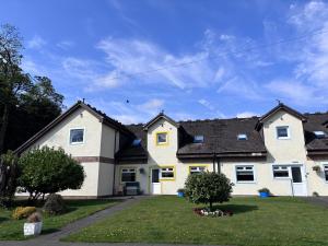 a white house with a black roof at Cunninghame 3 in Beith +15 photos