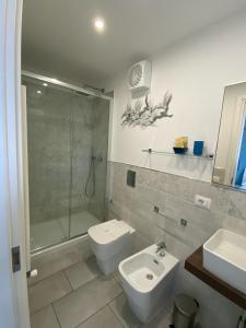 a bathroom with a shower and a toilet and a sink at Oltre il Blu in La Spezia