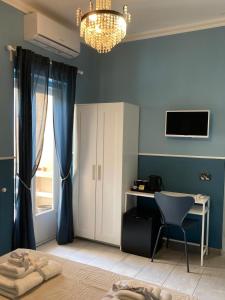 a blue room with a desk and a chair at Oltre il Blu in La Spezia +16 photos
