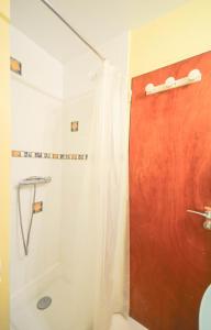 a shower in a bathroom with a red door at Chez Alain - Confortable appartement et vue à couper le souffle in La Grande-Motte +11 photos