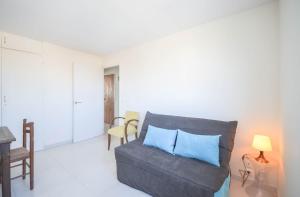 a living room with a couch and a table at Chez Alain - Confortable appartement et vue à couper le souffle in La Grande-Motte